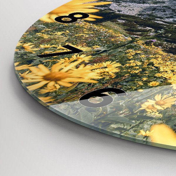 Round glass clock Meadow flowers in the mountains