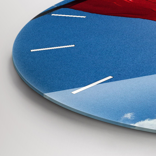 Round glass clock The Polish flag against the sky