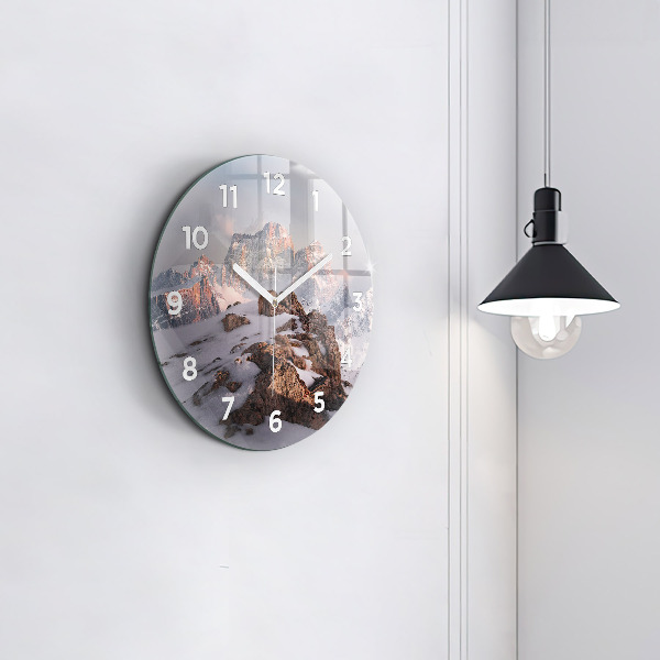 Round glass clock A mountain covered in snow