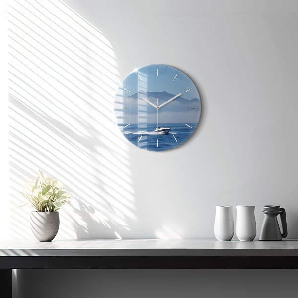 Round glass clock A boat floating on the ocean