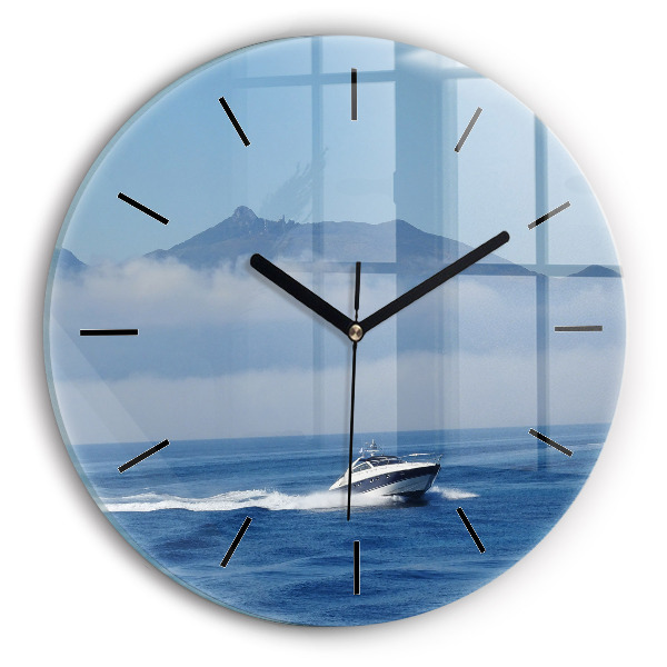 Round glass clock A boat floating on the ocean