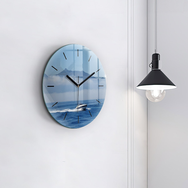 Round glass clock A boat floating on the ocean