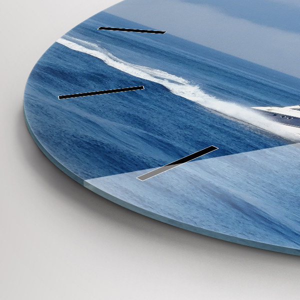 Round glass clock A boat floating on the ocean