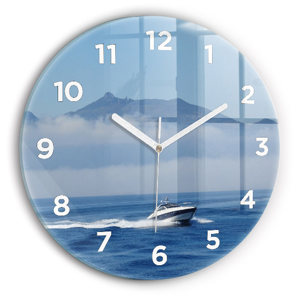 Round glass clock A boat floating on the ocean