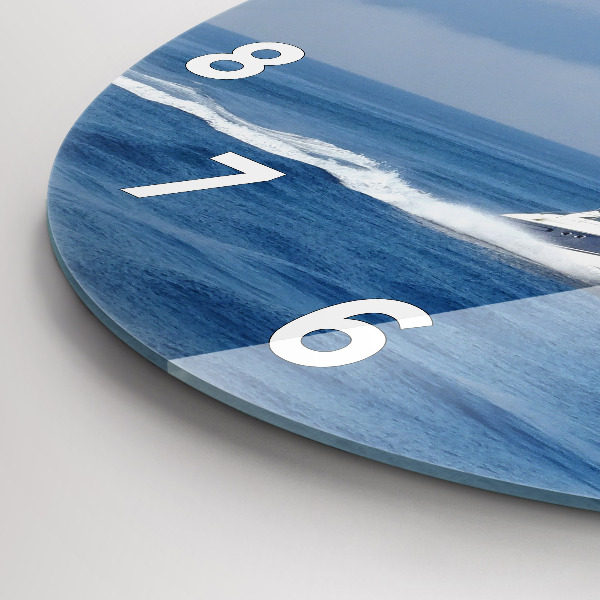 Round glass clock A boat floating on the ocean