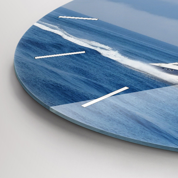 Round glass clock A boat floating on the ocean