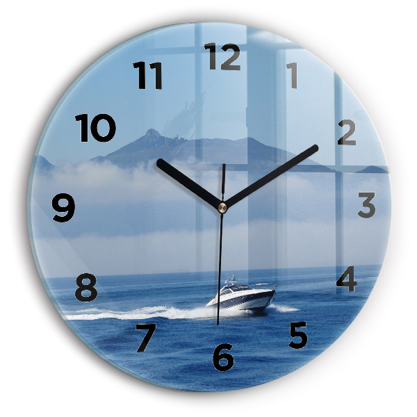 Round glass clock A boat floating on the ocean