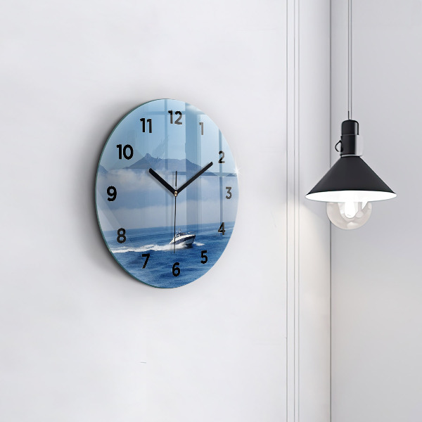 Round glass clock A boat floating on the ocean