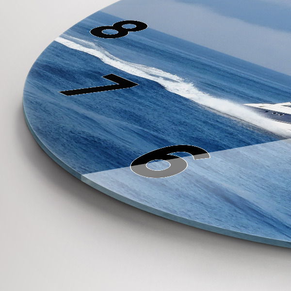 Round glass clock A boat floating on the ocean