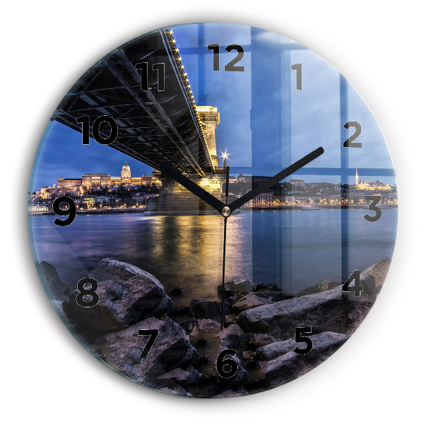 Round glass clock Rocky shore under the bridge