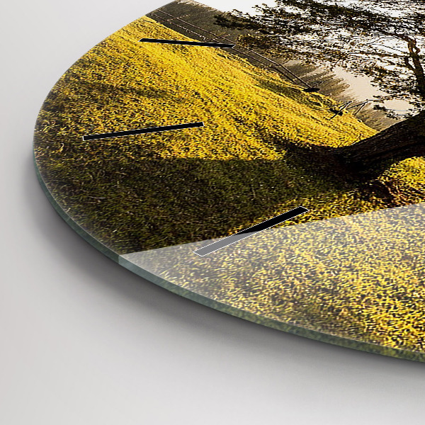Round glass clock A tree on a hill