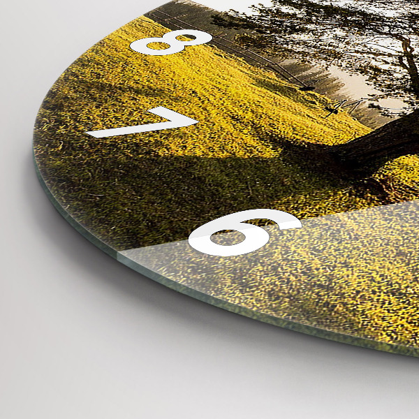 Round glass clock A tree on a hill