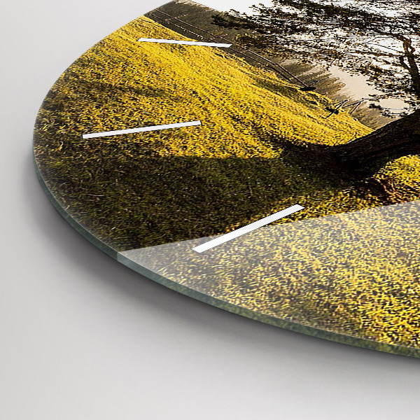 Round glass clock A tree on a hill