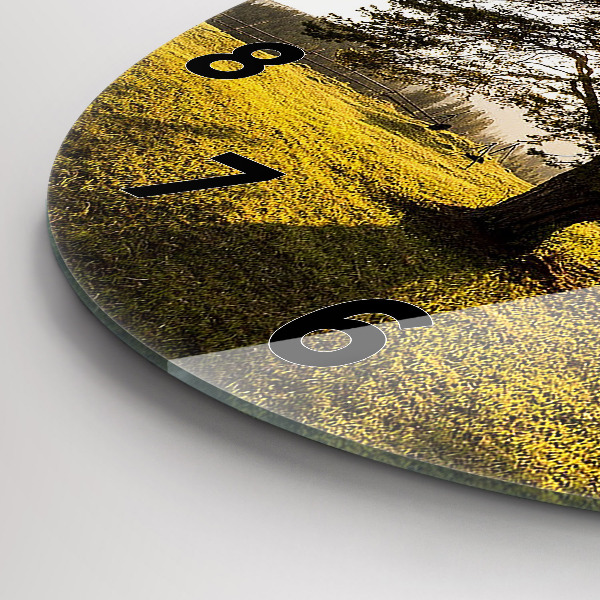 Round glass clock A tree on a hill