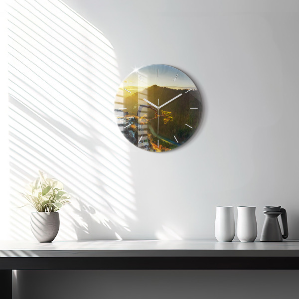 Round glass clock Sunset over the mountains