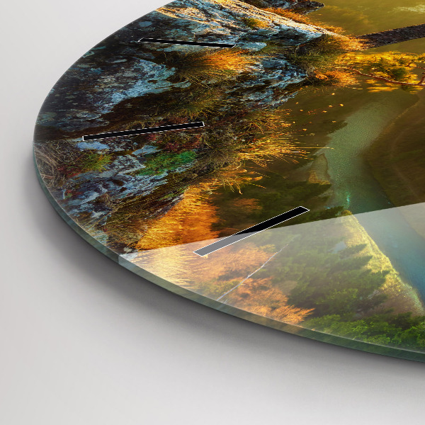 Round glass clock Sunset over the mountains