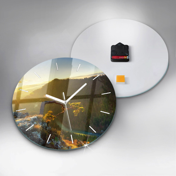 Round glass clock Sunset over the mountains