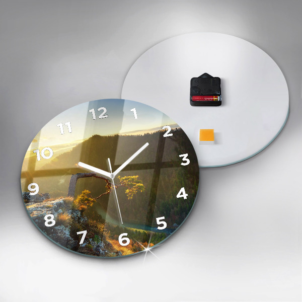 Round glass clock Sunset over the mountains