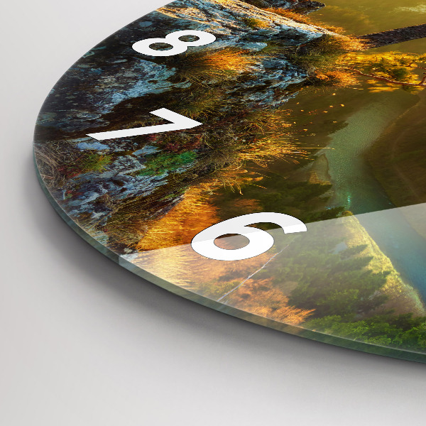 Round glass clock Sunset over the mountains