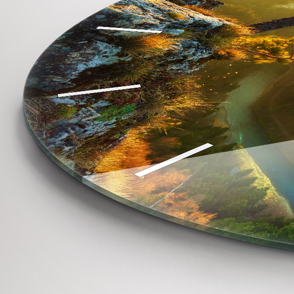 Round glass clock Sunset over the mountains