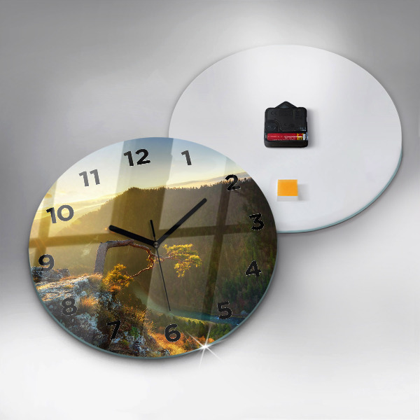 Round glass clock Sunset over the mountains