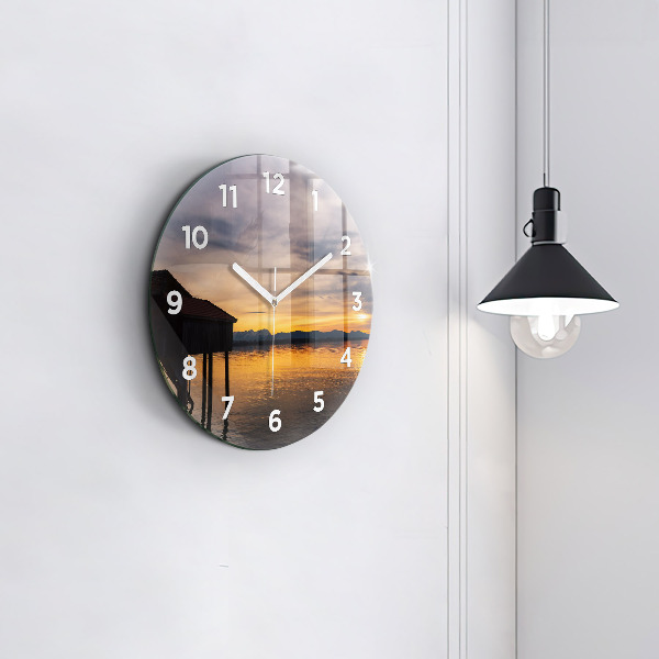 Round glass clock Sunset over the lake