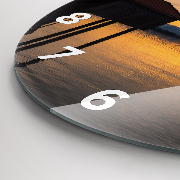 Round glass clock Sunset over the lake