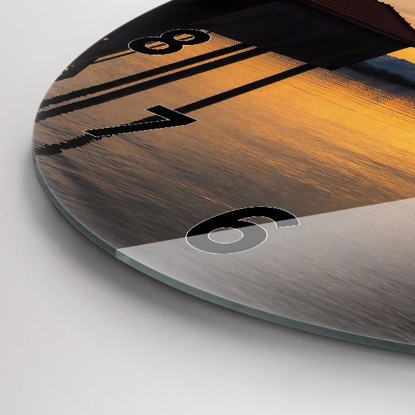 Round glass clock Sunset over the lake