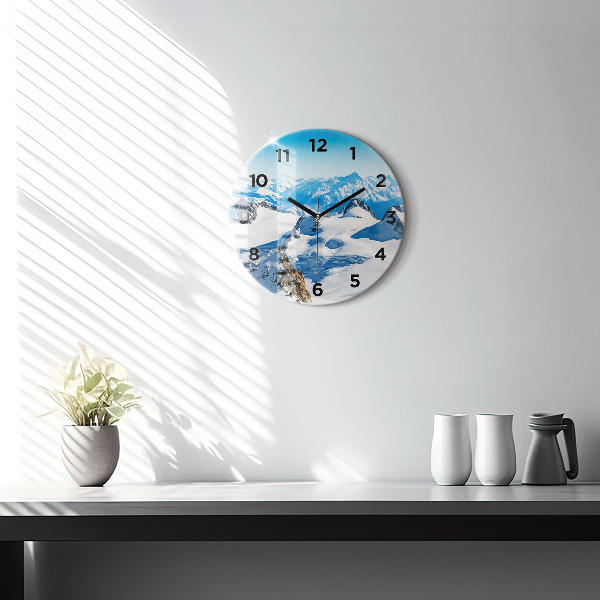 Round glass clock Skier in the Alps