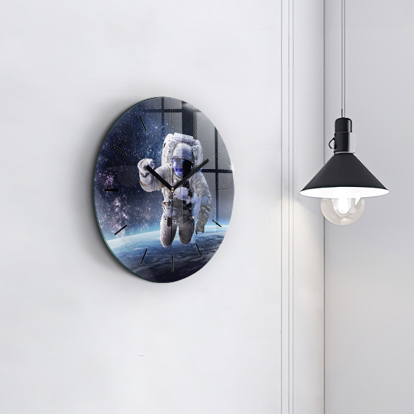 Round glass clock Astronaut above the earth