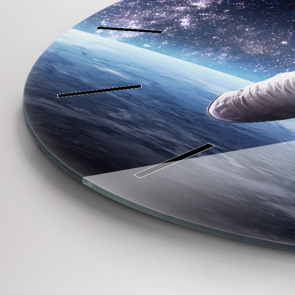 Round glass clock Astronaut above the earth