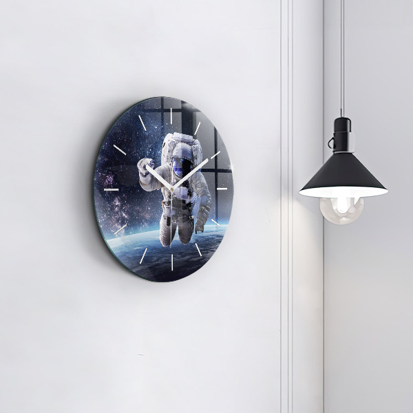 Round glass clock Astronaut above the earth