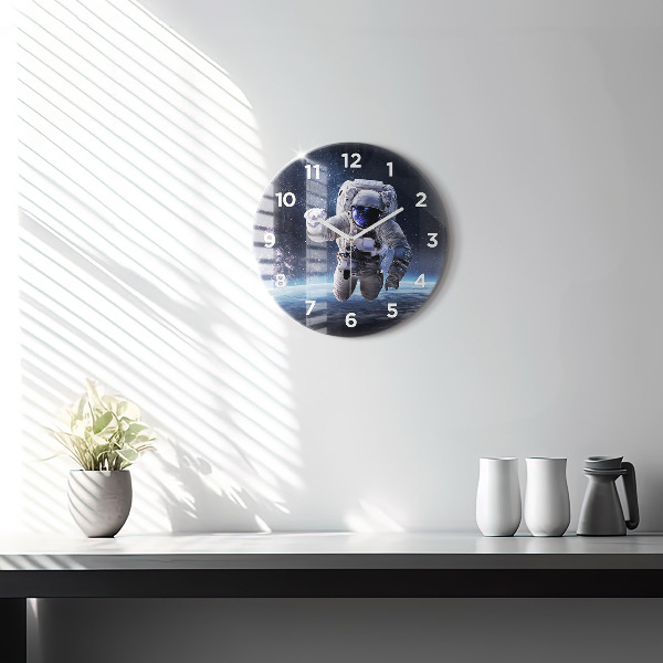 Round glass clock Astronaut above the earth