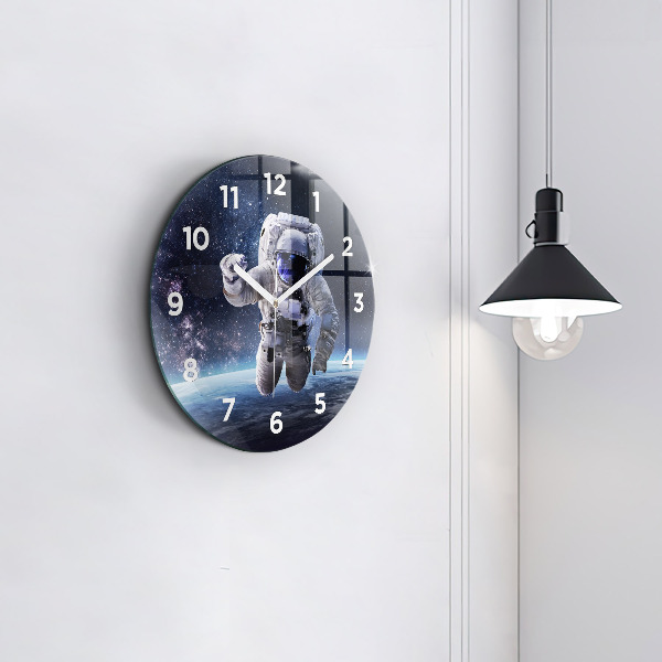 Round glass clock Astronaut above the earth