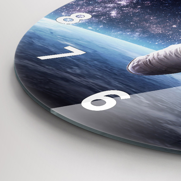 Round glass clock Astronaut above the earth