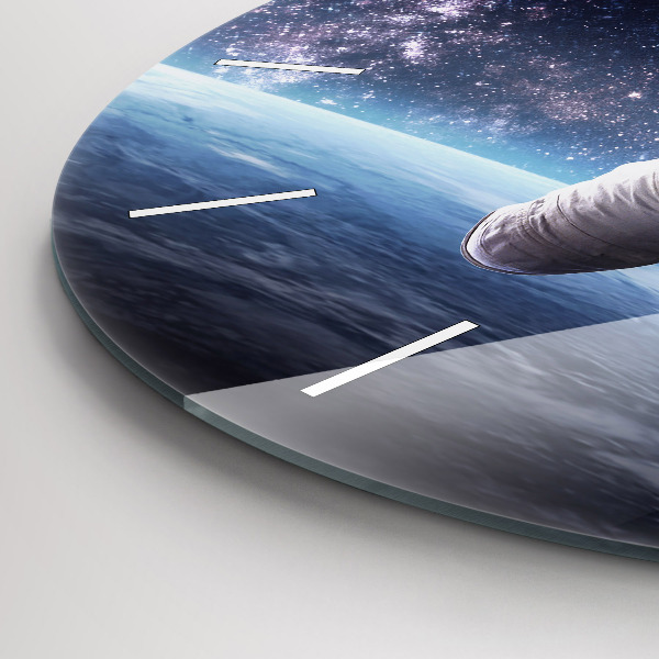 Round glass clock Astronaut above the earth