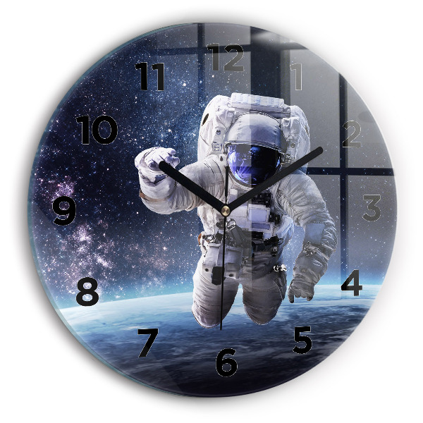 Round glass clock Astronaut above the earth