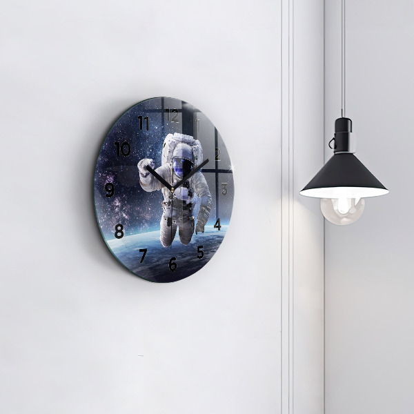 Round glass clock Astronaut above the earth