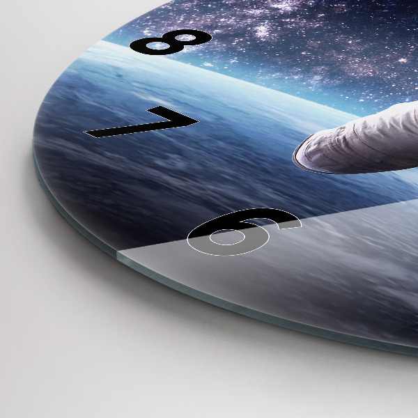 Round glass clock Astronaut above the earth