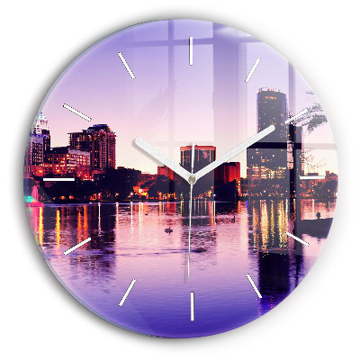 Round glass clock Evening panorama of the city