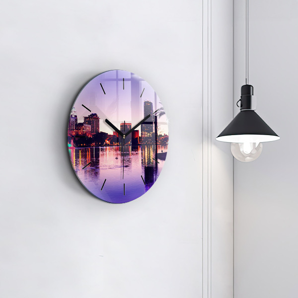 Round glass clock Evening panorama of the city