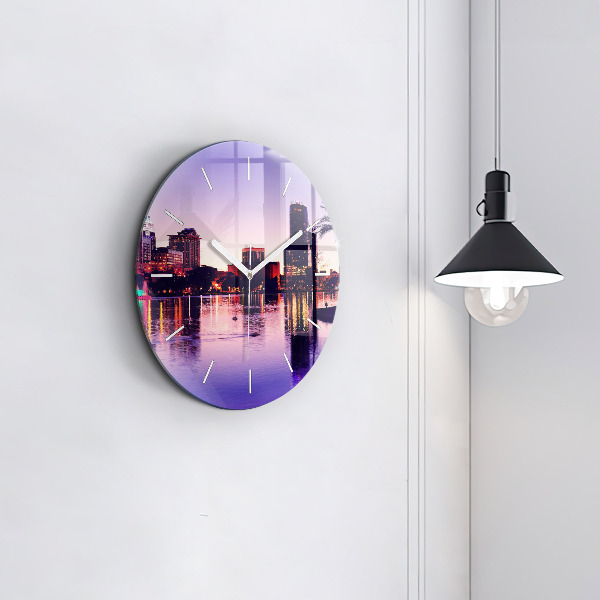 Round glass clock Evening panorama of the city