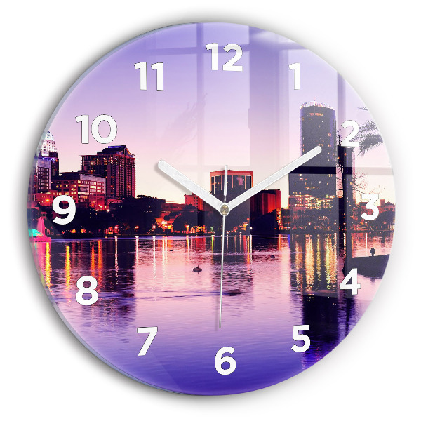 Round glass clock Evening panorama of the city