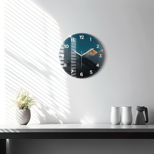 Round glass clock Sunset in the mountains