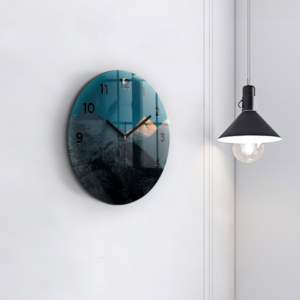 Round glass clock Sunset in the mountains