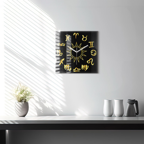 Square glass clock Golden astrological signs on black background