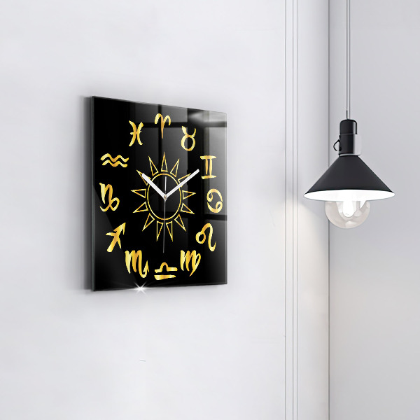 Square glass clock Golden astrological signs on black background